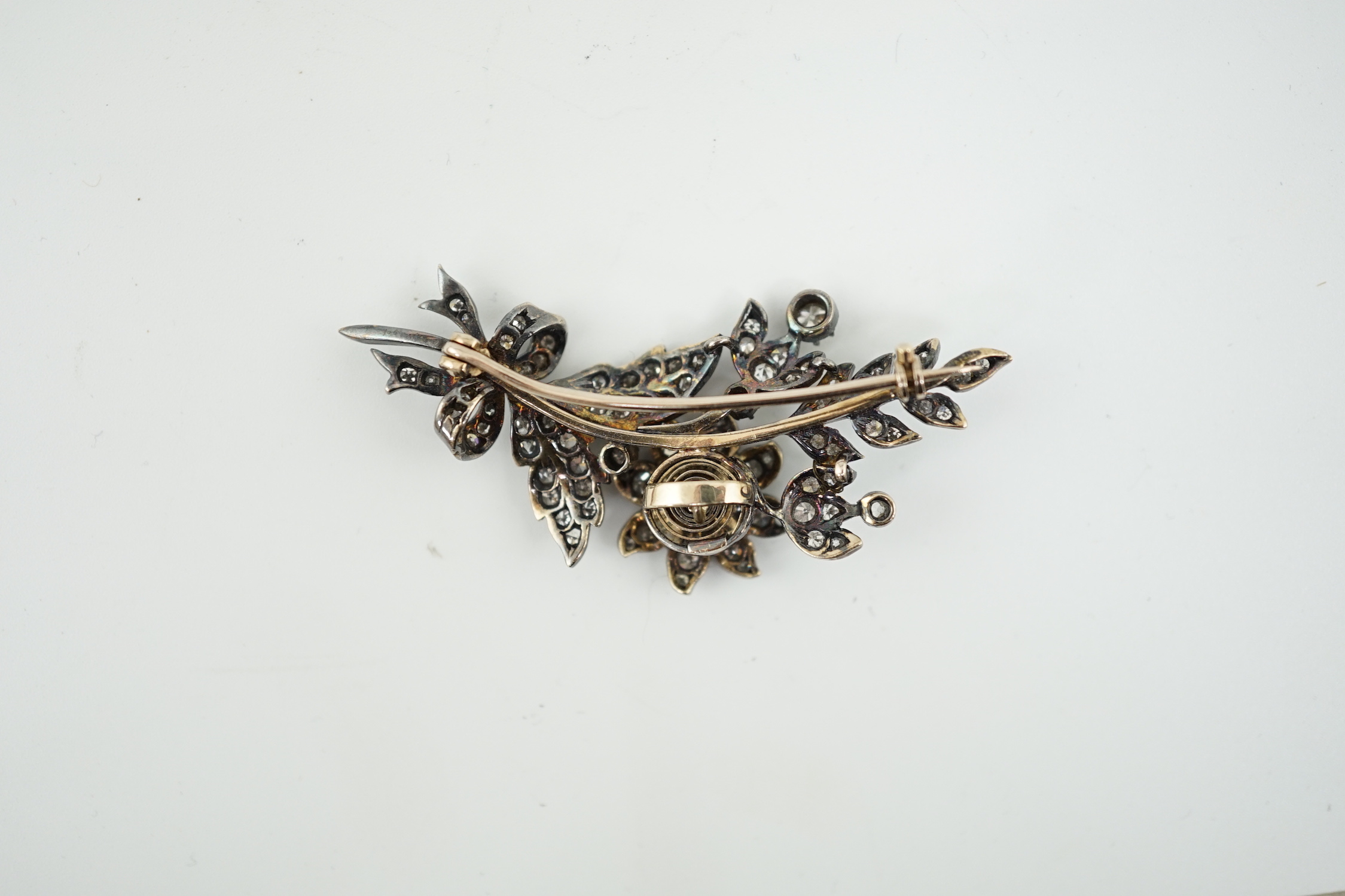 A late Victorian gold, silver and diamond cluster set trembleuse floral spray brooch